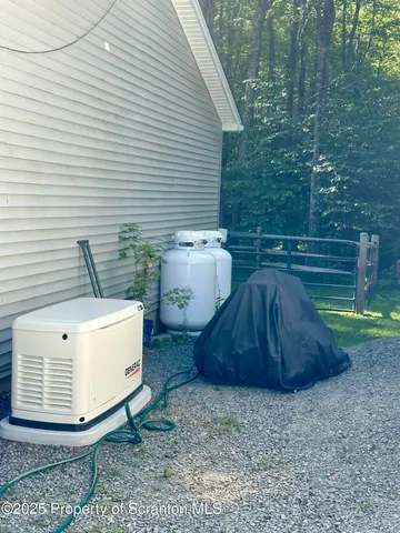 a view of a patio with table and chairs under an umbrella