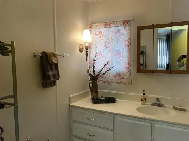 a bathroom with a sink and mirror