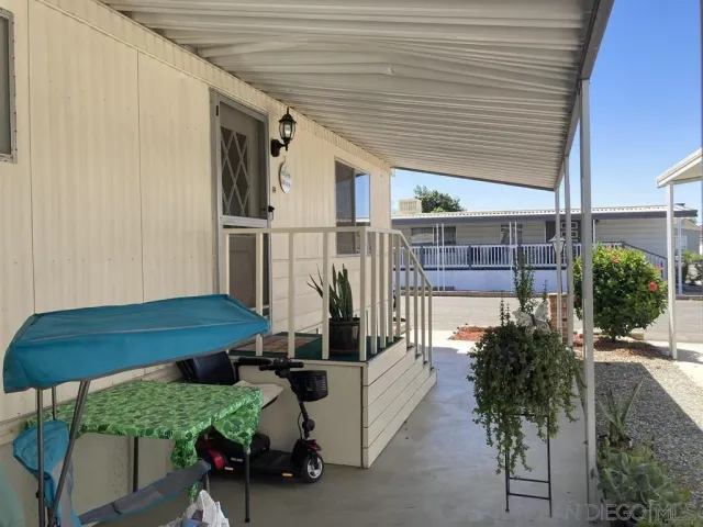 a view of a porch with furniture and a potted plant