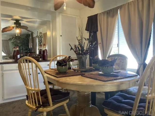 a dining room with furniture and window