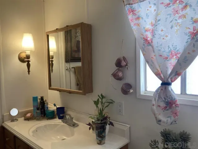 a bathroom with a sink and mirror