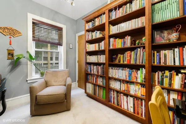 a livingroom with a book shelf and a window