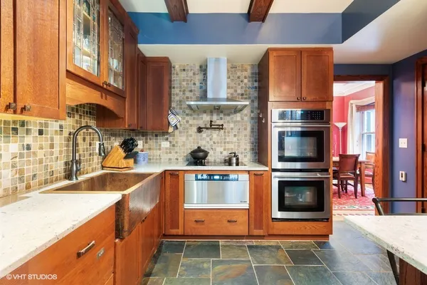a kitchen with a wooden cabinets and a stove top oven