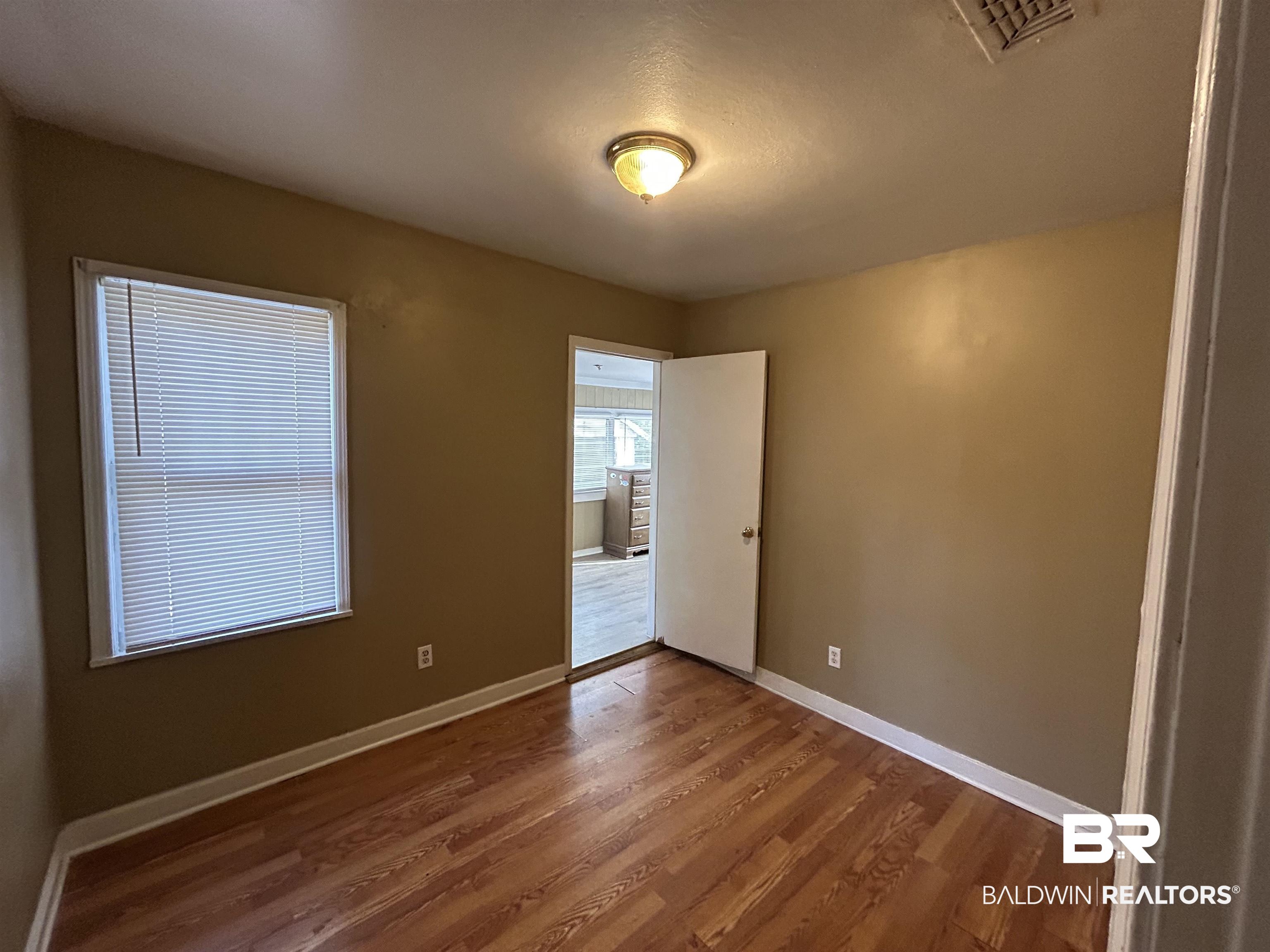 2119 Hoppin Street Mobile, AL 36605 - Photo 21 of 23 Spare room featuring hardwood / wood-style flooring