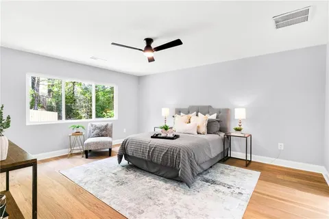 a bedroom with a large bed and a large window