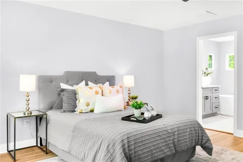 a bedroom with a bed and painting on the wall