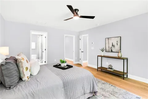 a bedroom with a bed and a painting on the wall