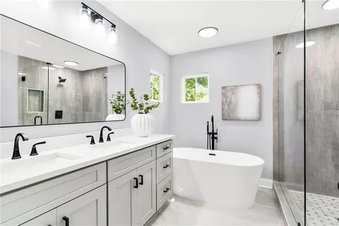 a bathroom with double sink and a mirror