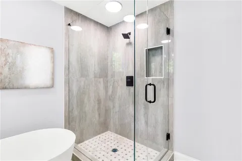 a bathroom with a shower and a toilet