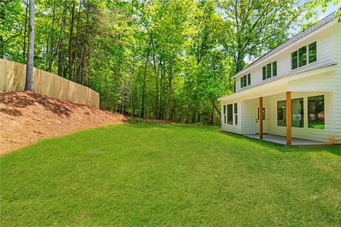 a view of a backyard with large trees