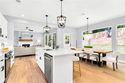 a very nice looking living room with a large window and wooden floor