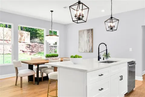 a kitchen with a table chairs and chandelier