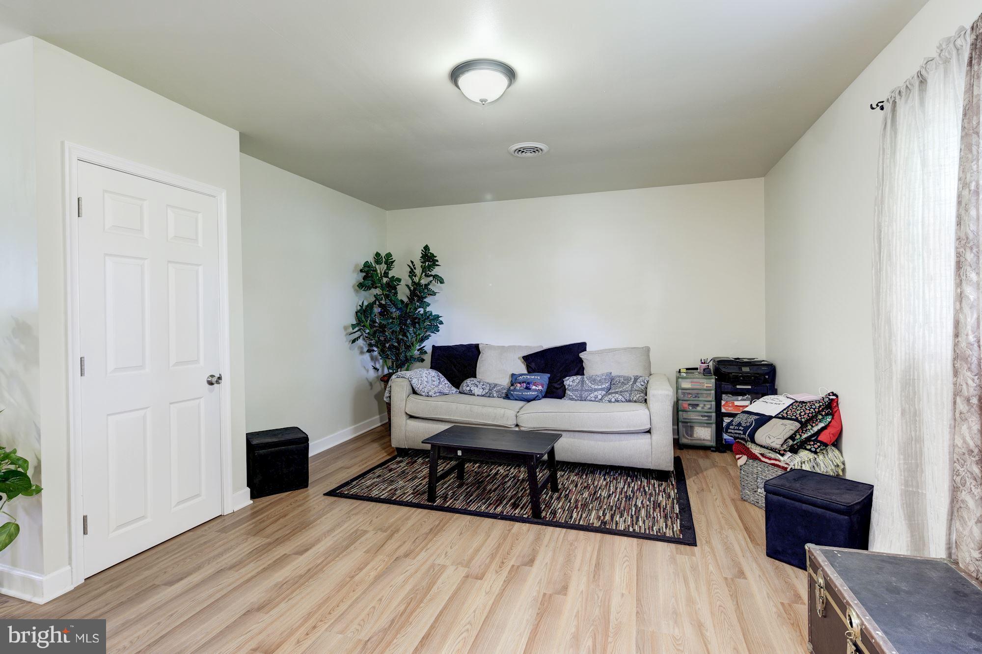 5905 Johnnycake Road Baltimore, MD 21228 - Photo 11 of 30 a living room with furniture and a wooden floor