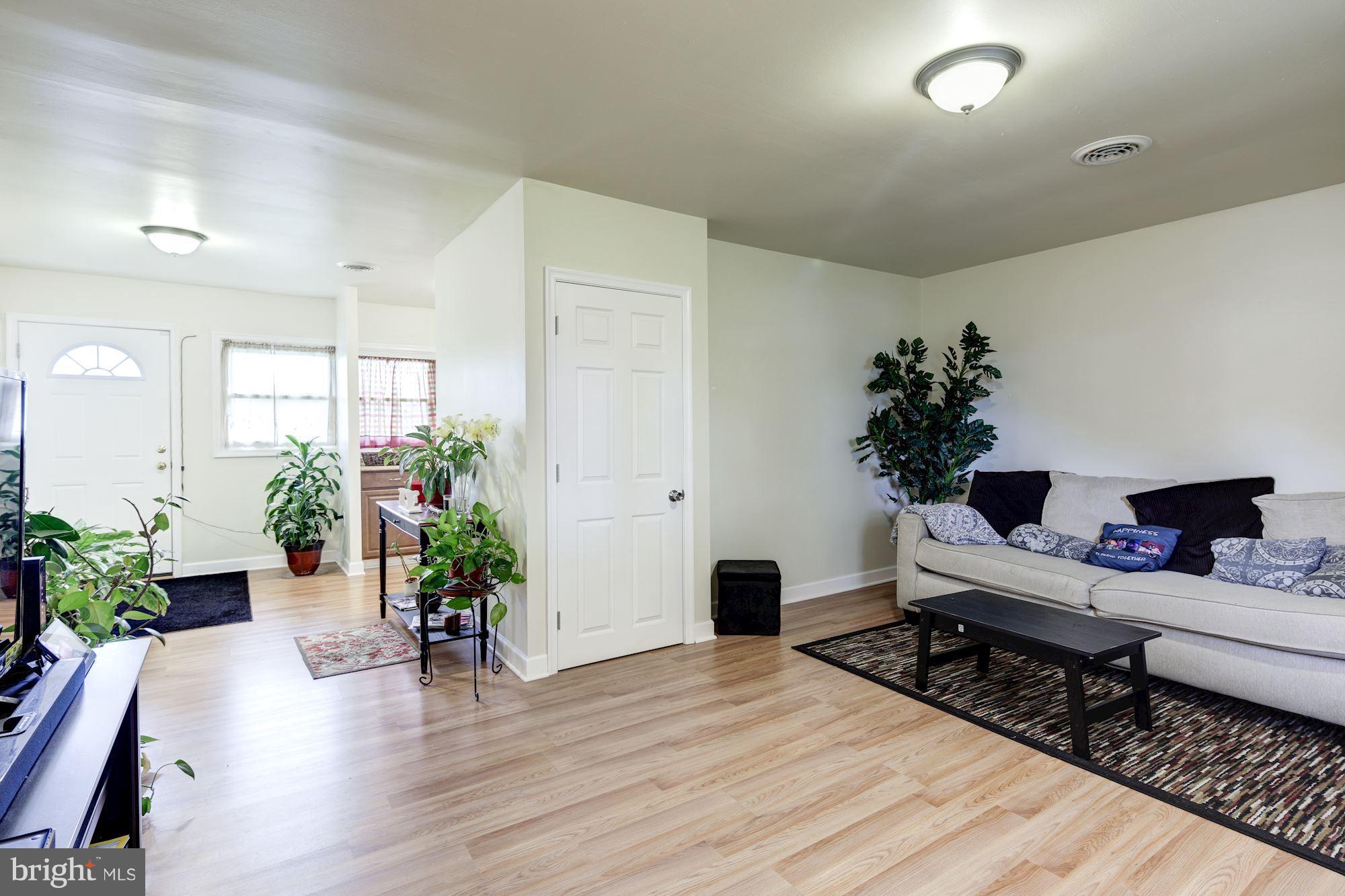 5905 Johnnycake Road Baltimore, MD 21228 - Photo 12 of 30 a living room with furniture and flowers