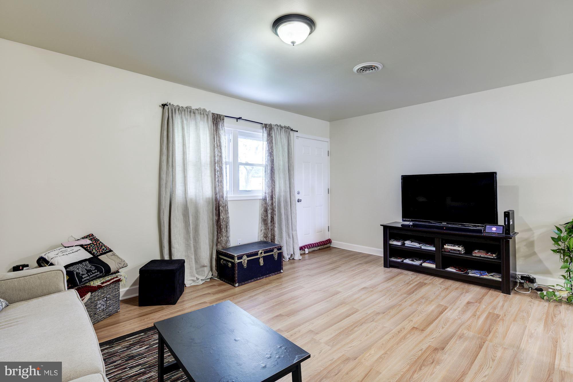 5905 Johnnycake Road Baltimore, MD 21228 - Photo 13 of 30 a living room with furniture and a flat screen tv