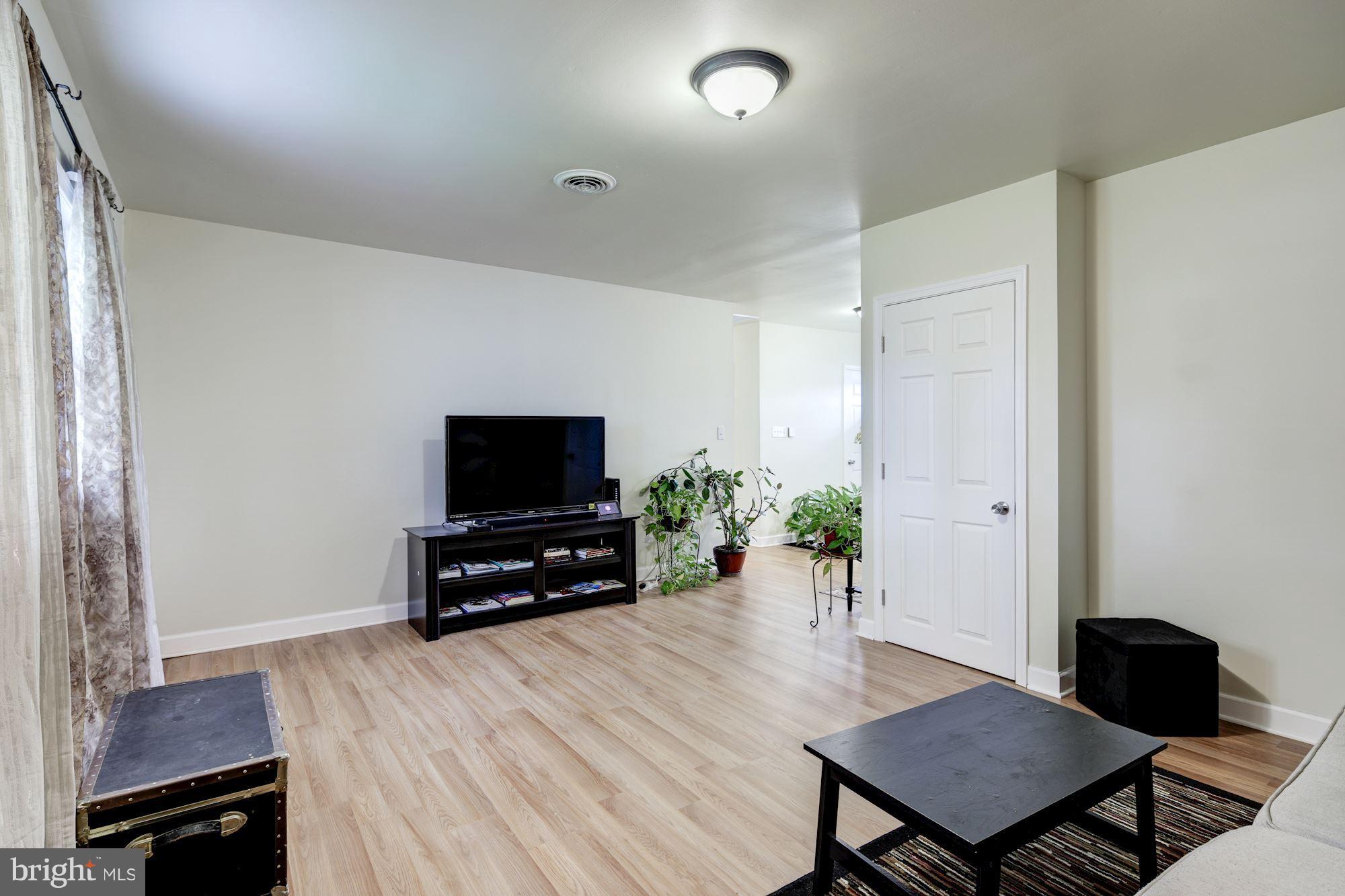 5905 Johnnycake Road Baltimore, MD 21228 - Photo 14 of 30 a living room with furniture and a flat screen tv