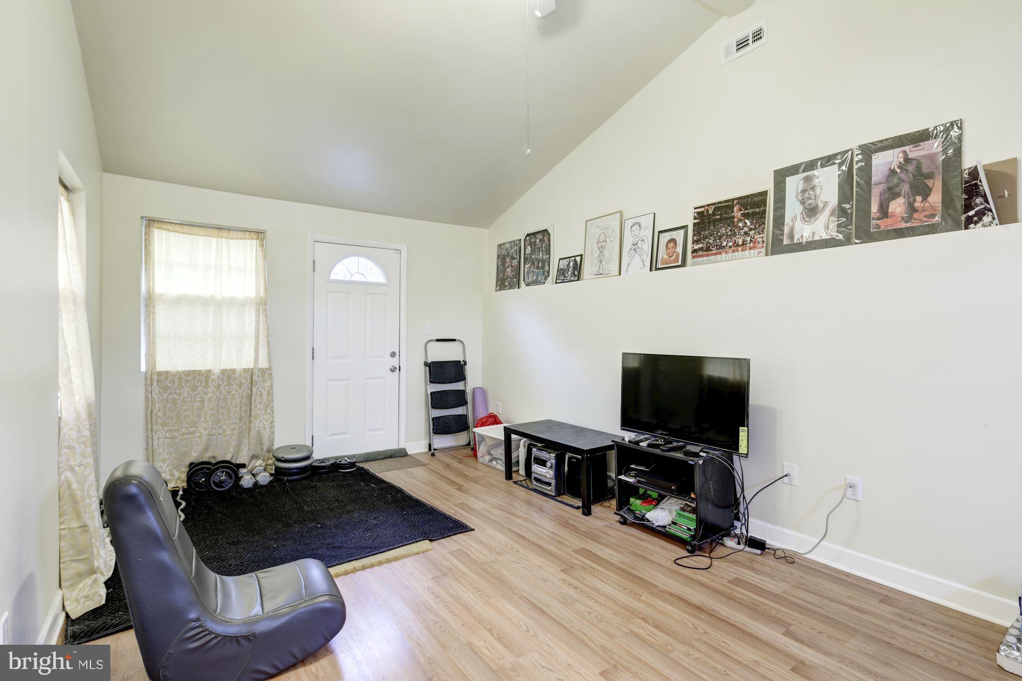 5905 Johnnycake Road Baltimore, MD 21228 - Photo 16 of 30 a living room with furniture and a flat screen tv