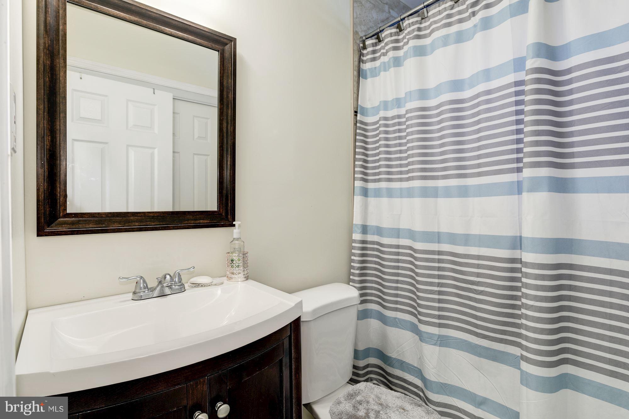5905 Johnnycake Road Baltimore, MD 21228 - Photo 19 of 30 a bathroom with a sink and a mirror