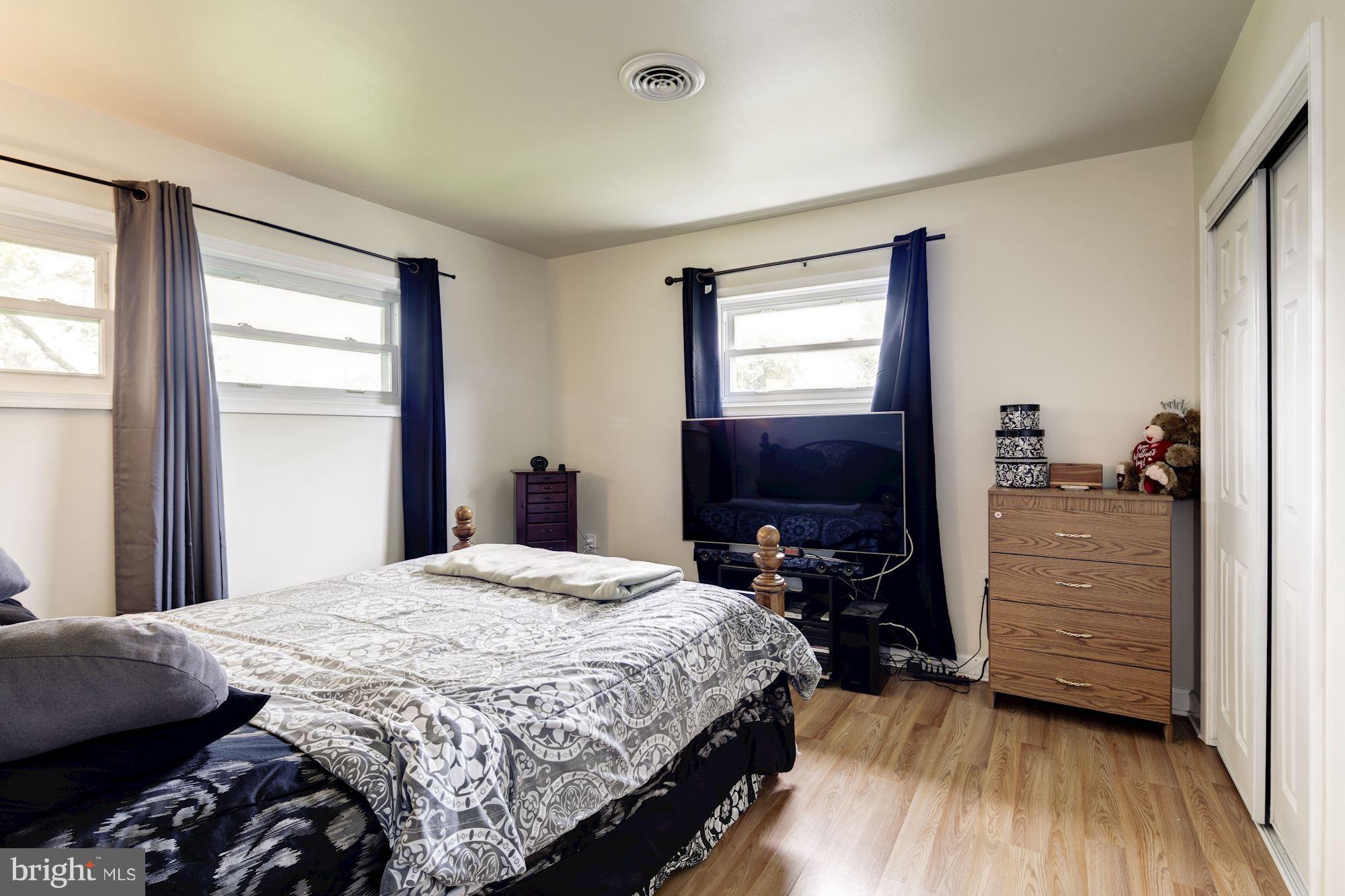 5905 Johnnycake Road Baltimore, MD 21228 - Photo 20 of 30 a bedroom with a bed and wooden floor