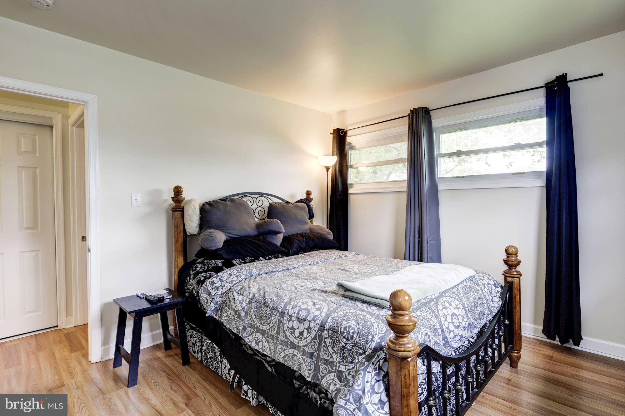 5905 Johnnycake Road Baltimore, MD 21228 - Photo 21 of 30 a bedroom with a bed and wooden floor