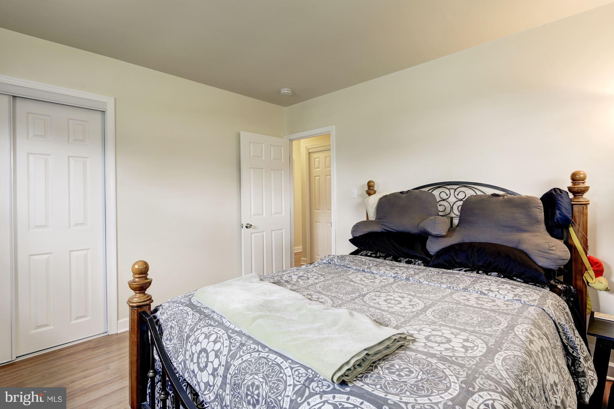 5905 Johnnycake Road Baltimore, MD 21228 - Photo 22 of 30 a bedroom with a bed and wooden floor