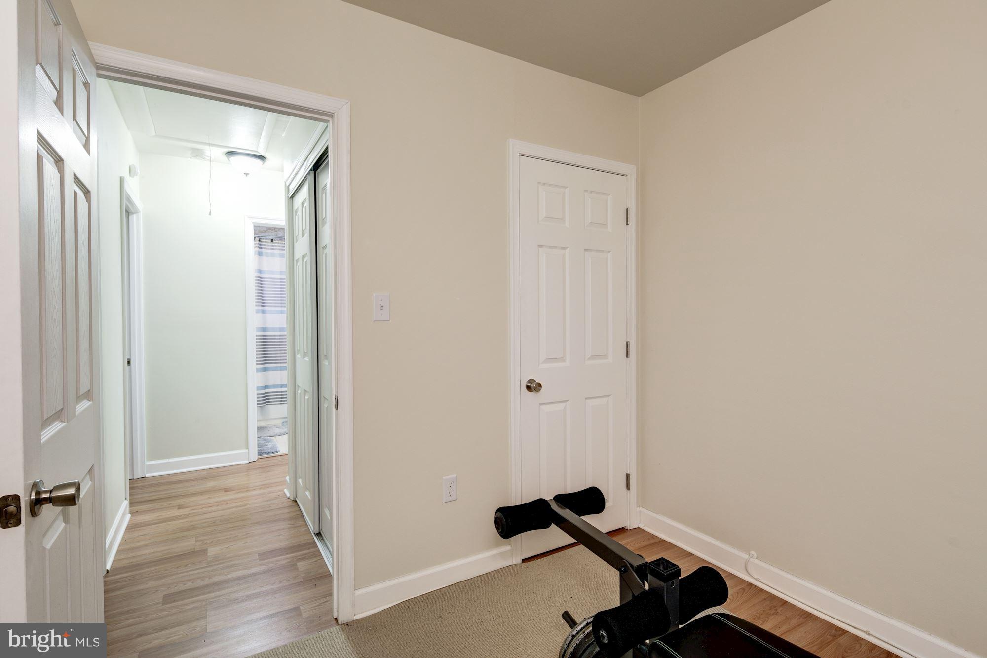 5905 Johnnycake Road Baltimore, MD 21228 - Photo 27 of 30 a view of a room with wooden floor and a bathroom