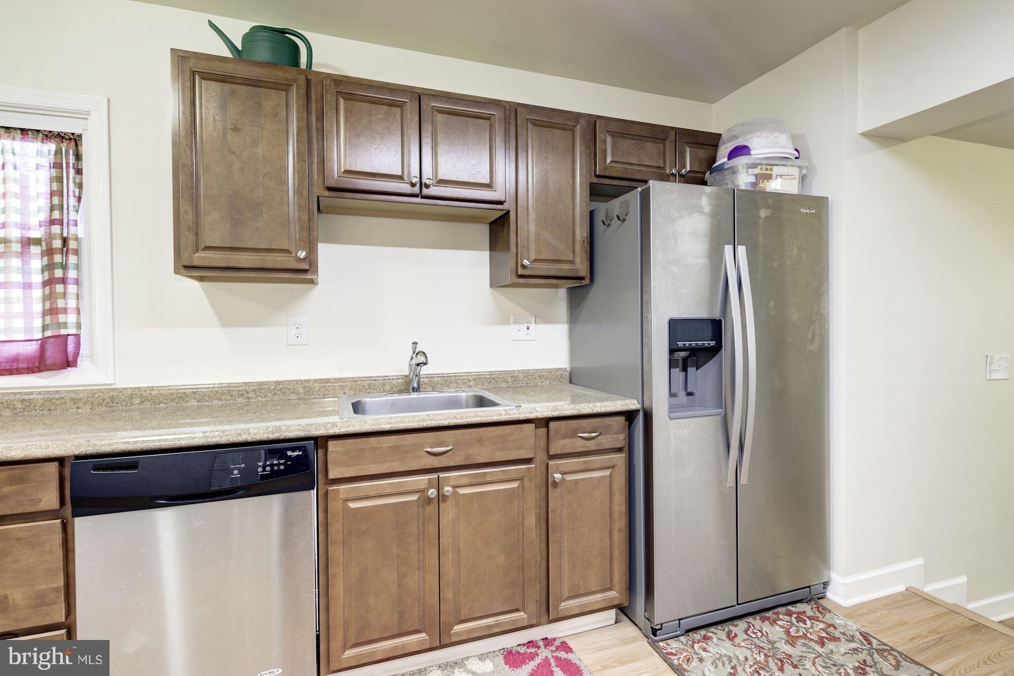 5905 Johnnycake Road Baltimore, MD 21228 - Photo 8 of 30 a kitchen with granite countertop stainless steel appliances a refrigerator and cabinets