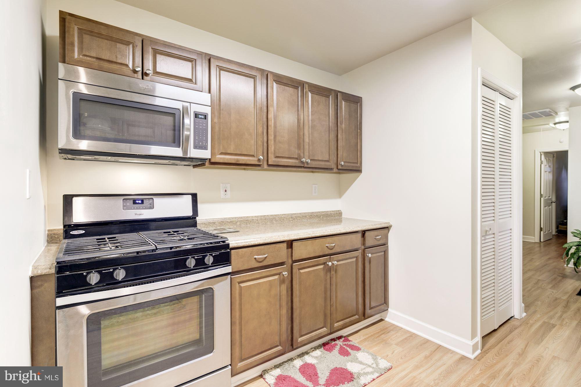 5905 Johnnycake Road Baltimore, MD 21228 - Photo 9 of 30 a kitchen with granite countertop cabinets stainless steel appliances and wooden floor