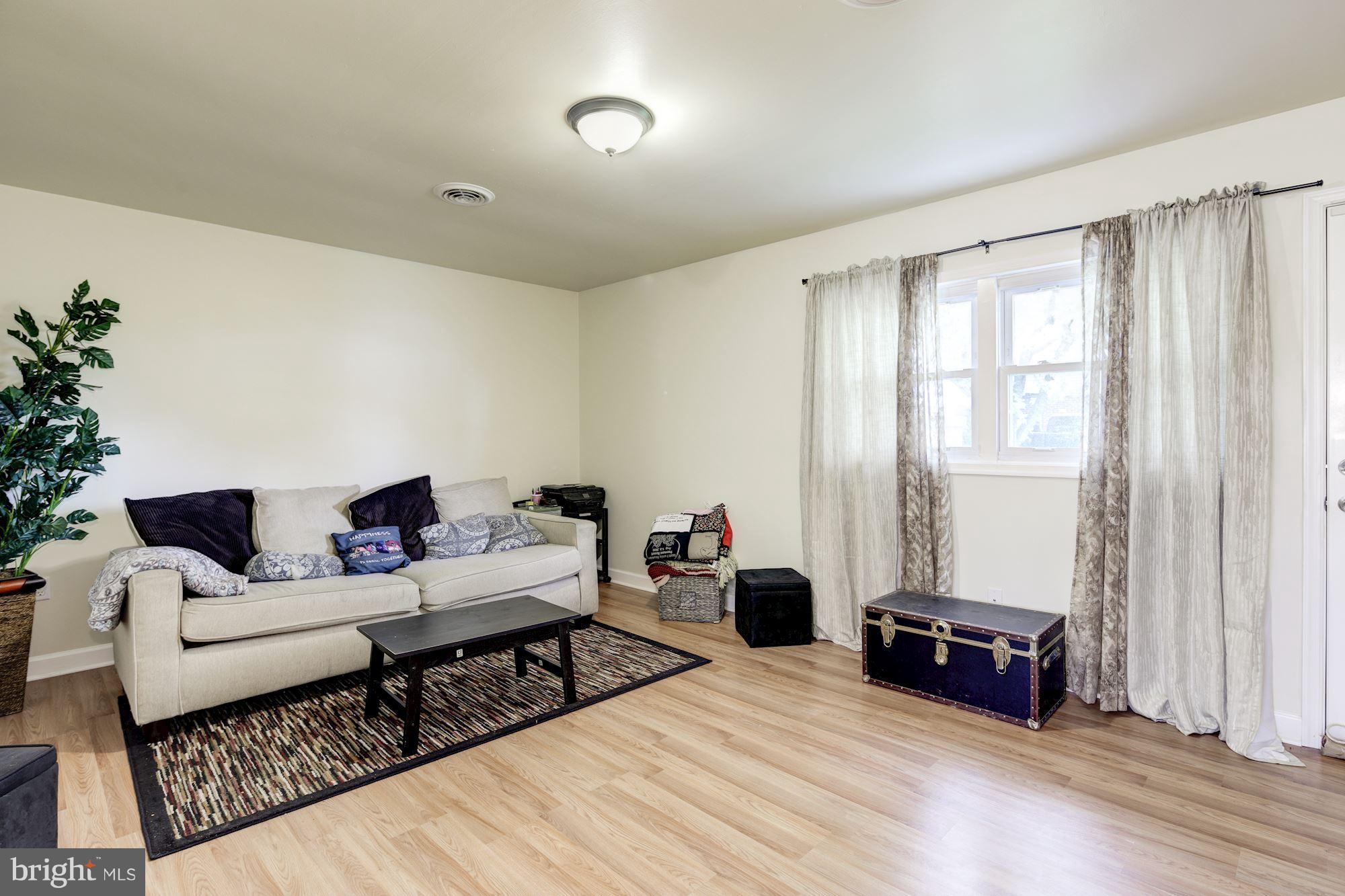 5905 Johnnycake Road Baltimore, MD 21228 - Photo 10 of 30 a living room with furniture and wooden floor