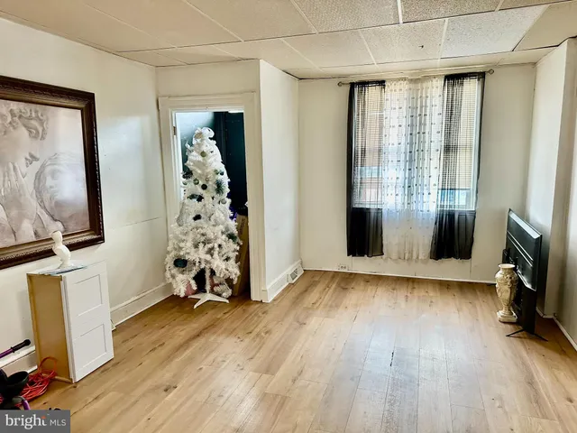 a view of a livingroom with hardwood floor and a window