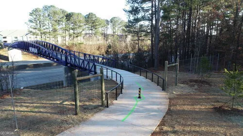 a view of a pathway with a yard in front of it