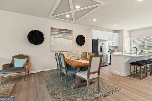 a view of a dining room with furniture and wooden floor