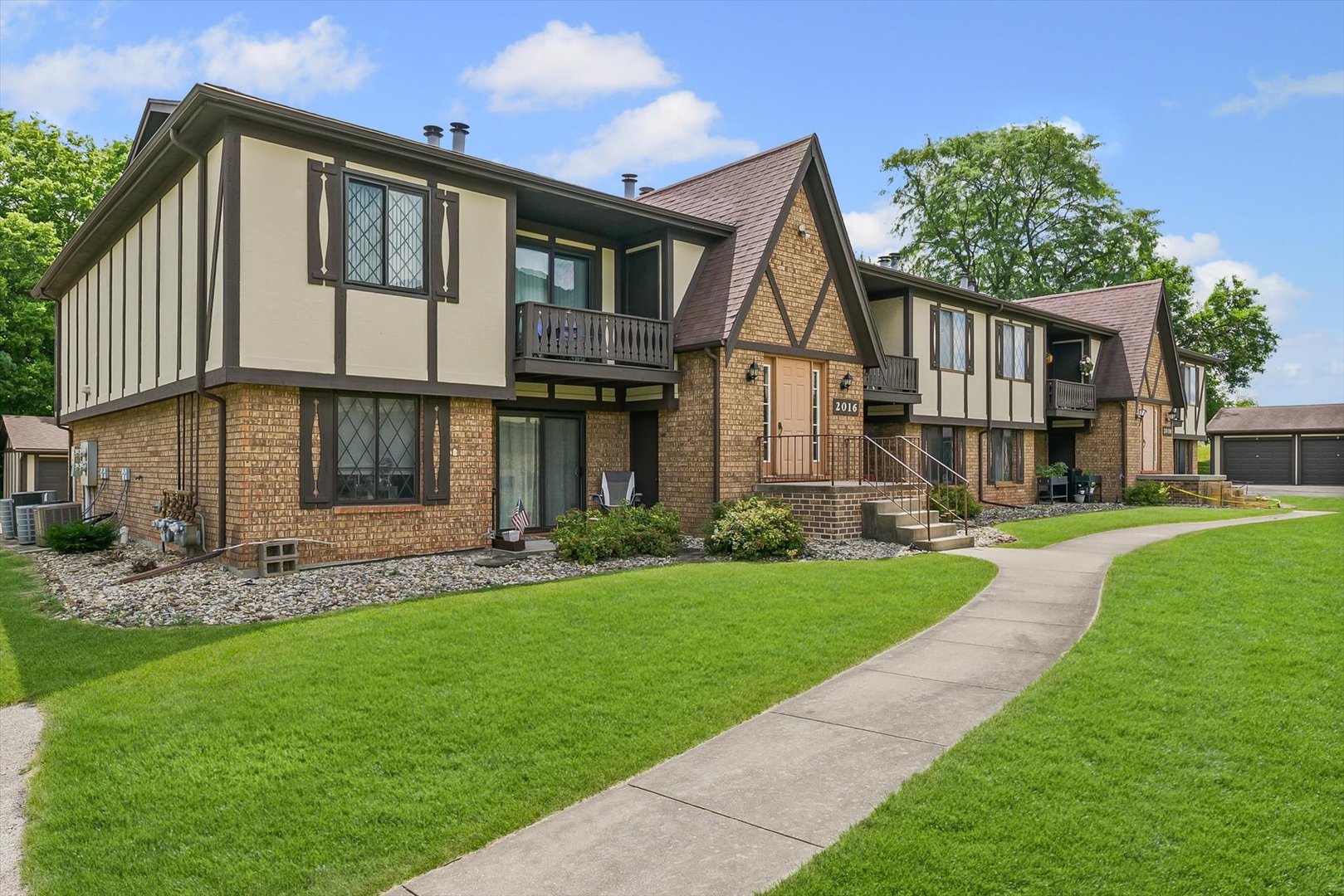 a front view of a house with a garden and yard