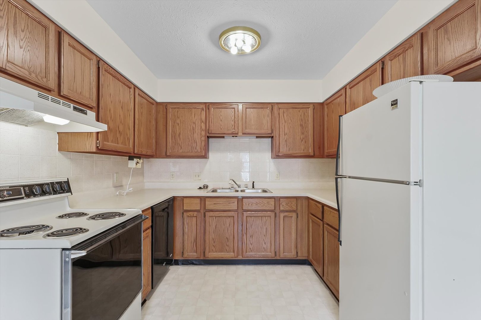 2016 Tracy Drive, Unit 3 Saybrook, IL 61770 - Photo 14 of 29 a kitchen with a sink a stove and cabinets