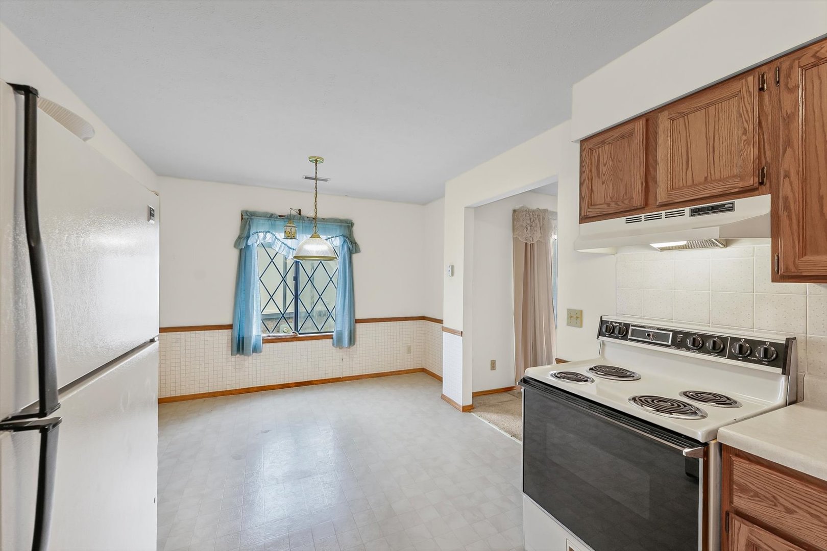 2016 Tracy Drive, Unit 3 Saybrook, IL 61770 - Photo 17 of 29 a kitchen with stainless steel appliances granite countertop a refrigerator a stove and a sink with wooden cabinets