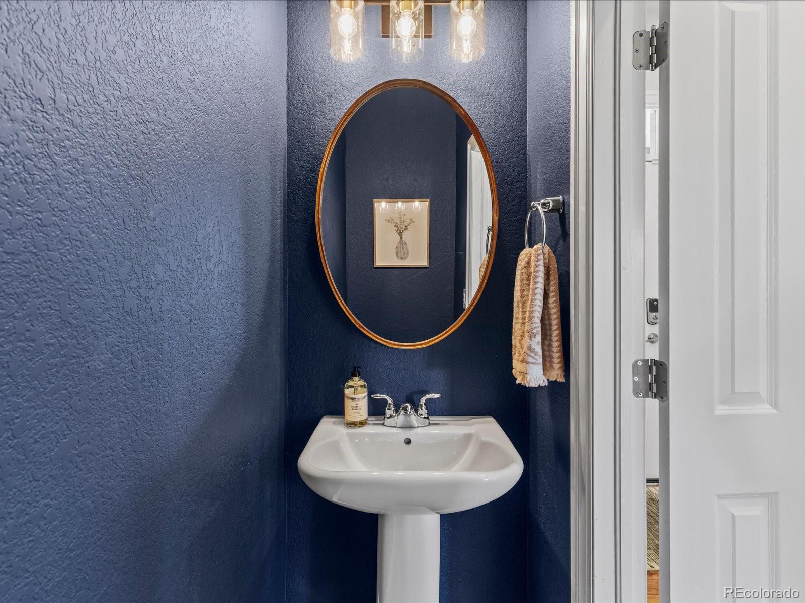 5446 Uinta Way Denver, CO 80238 - Photo 19 of 49 a bathroom with a sink and a mirror