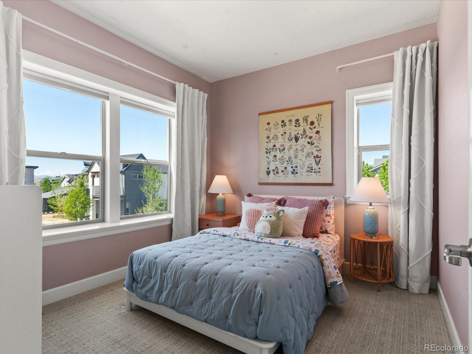 5446 Uinta Way Denver, CO 80238 - Photo 21 of 49 a bedroom with a large bed and a window