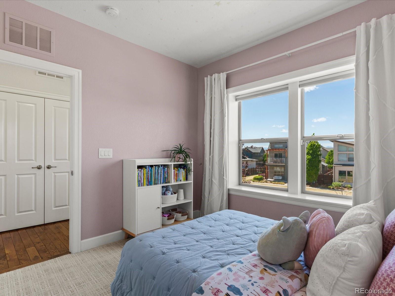 5446 Uinta Way Denver, CO 80238 - Photo 22 of 49 a bedroom with a large bed and a window