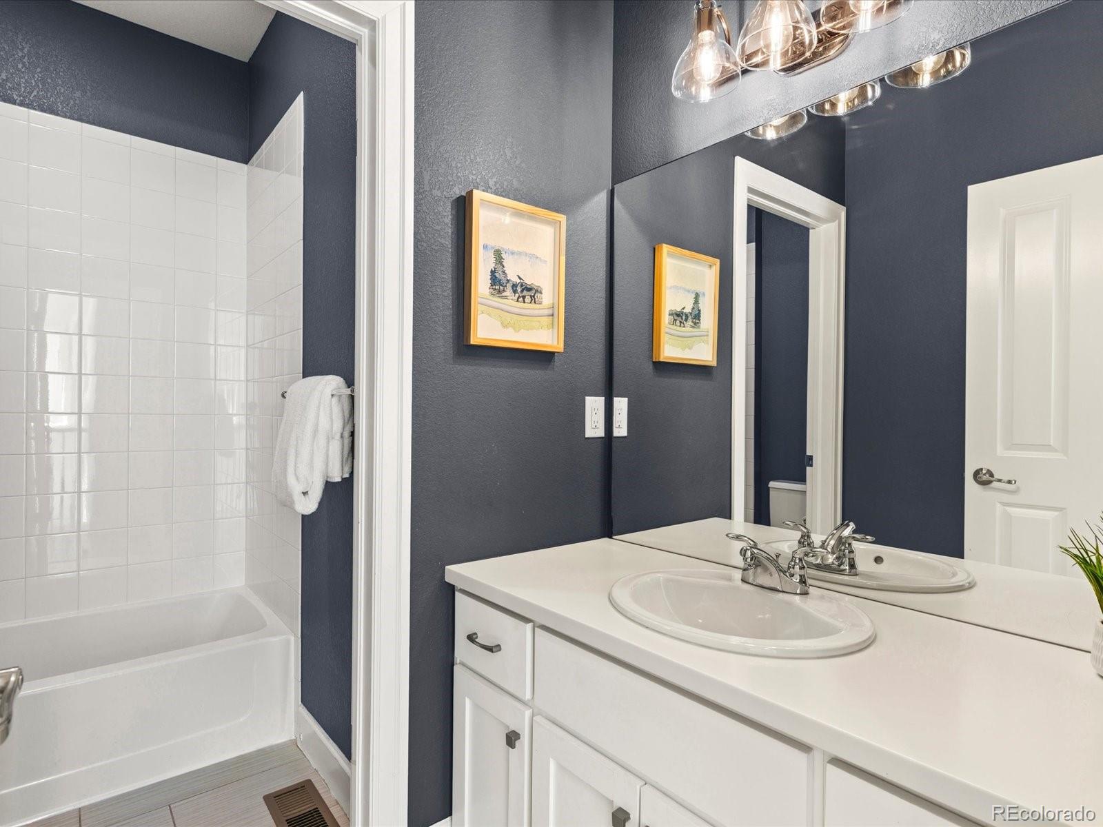 5446 Uinta Way Denver, CO 80238 - Photo 25 of 49 a bathroom with a sink and a mirror