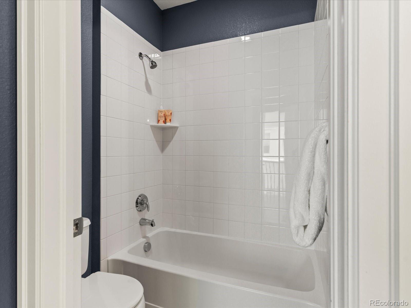 5446 Uinta Way Denver, CO 80238 - Photo 26 of 49 a bathroom with a shower and a bath tub