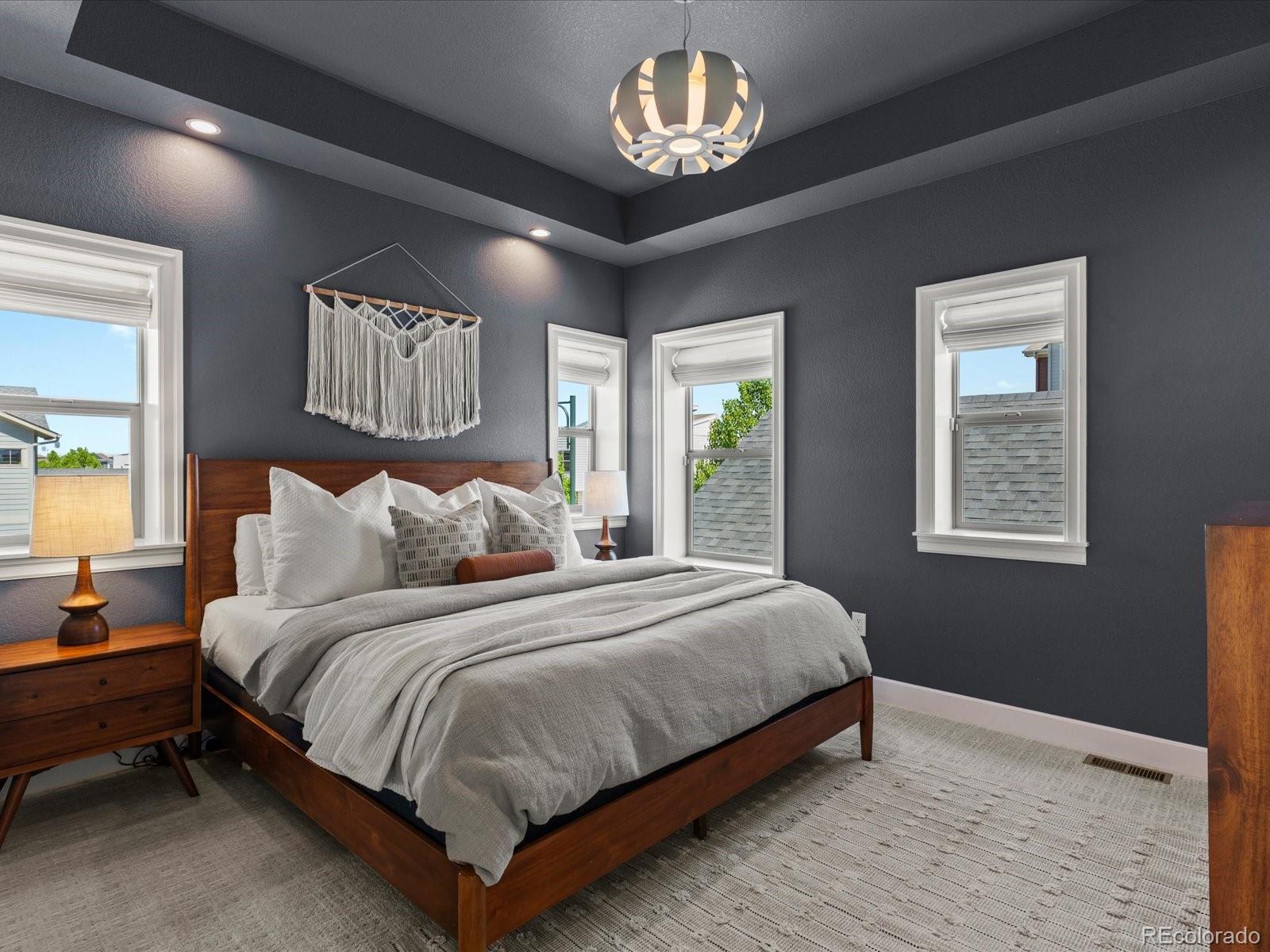 5446 Uinta Way Denver, CO 80238 - Photo 27 of 49 a bedroom with a bed and a chandelier