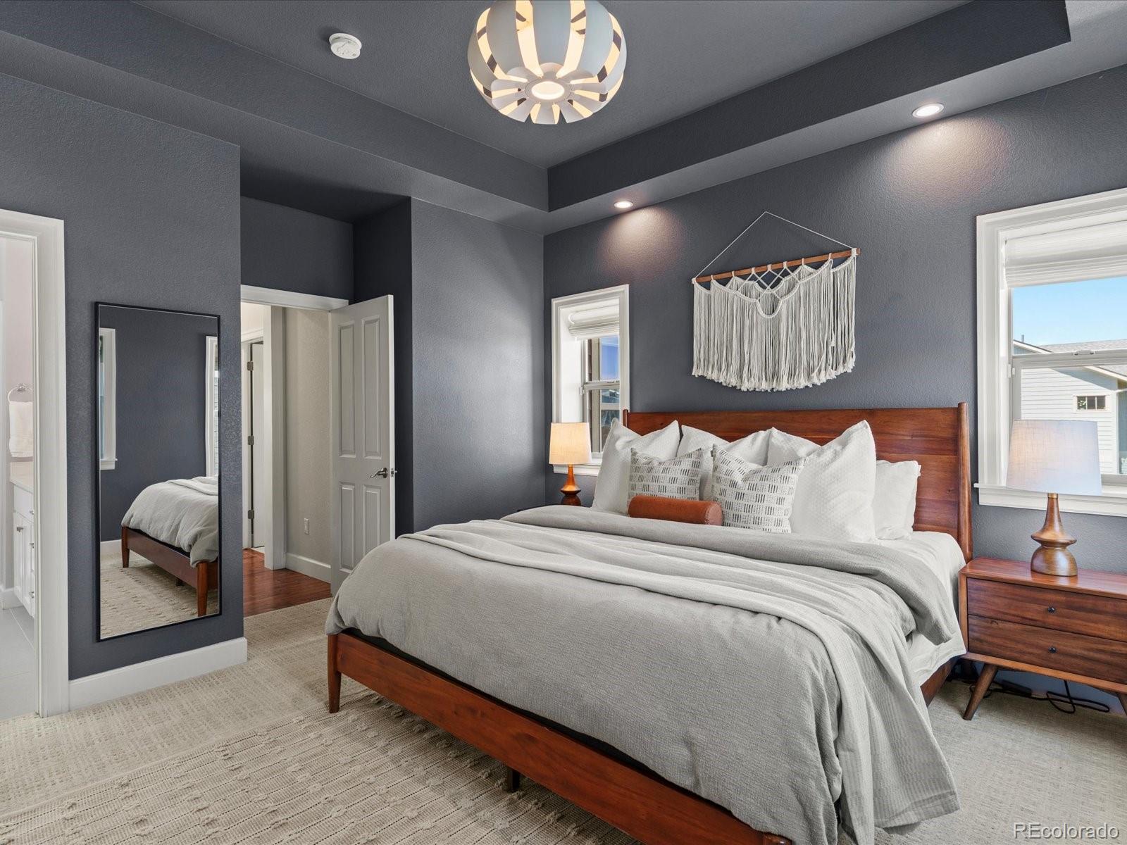5446 Uinta Way Denver, CO 80238 - Photo 28 of 49 a spacious bedroom with a bed and a large mirror in it