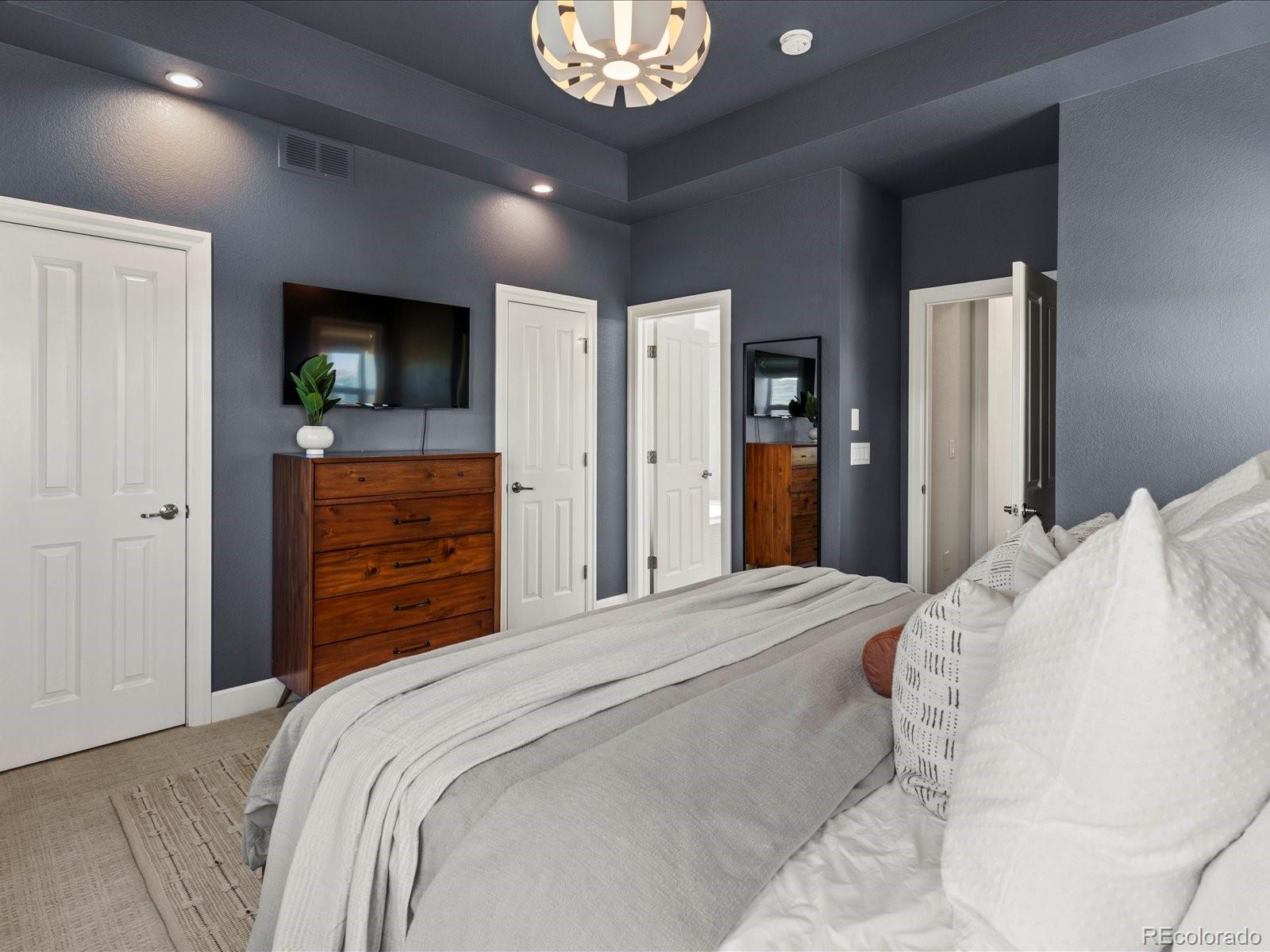 5446 Uinta Way Denver, CO 80238 - Photo 29 of 49 a bedroom with a bed and a television