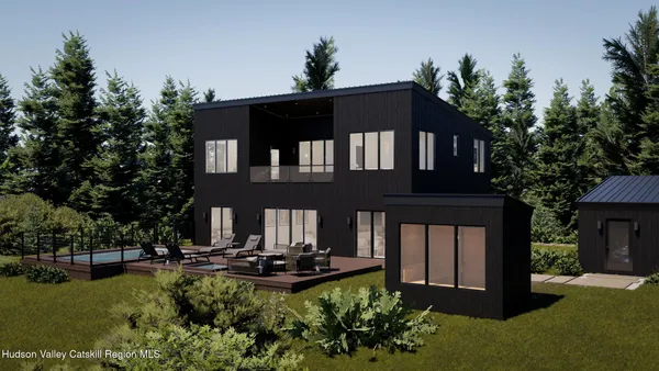 a front view of a house with swimming pool having outdoor seating