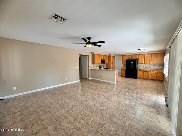 a view of a livingroom with a ceiling fan and window