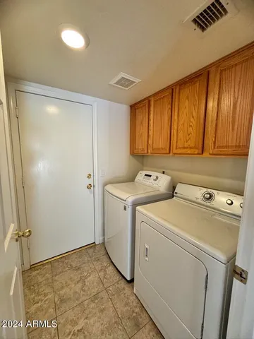 an empty room with closet and windows