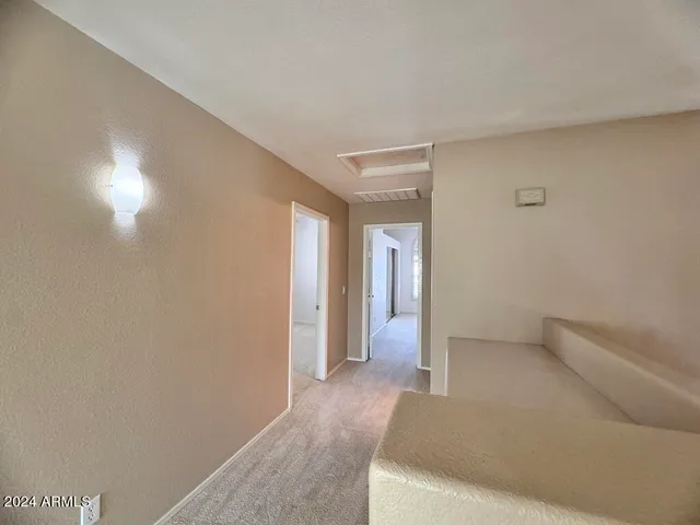 an empty room with a ceiling fan and a window