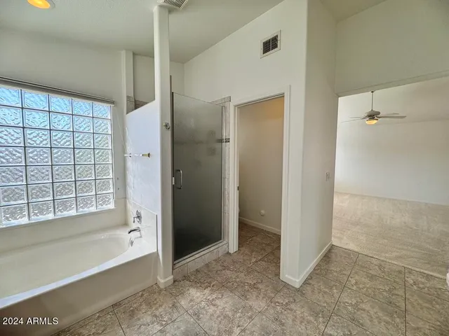 a view of an empty room with a window and closet