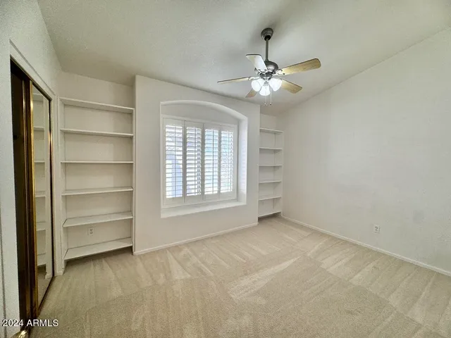 an empty room with a empty space and a ceiling fan