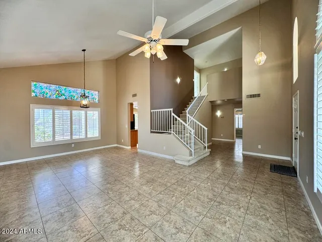 a view of a livingroom with a ceiling fan and window